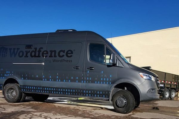 Commercial van with custom black car warp